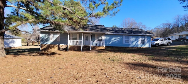 view of front of house with a front yard and a porch