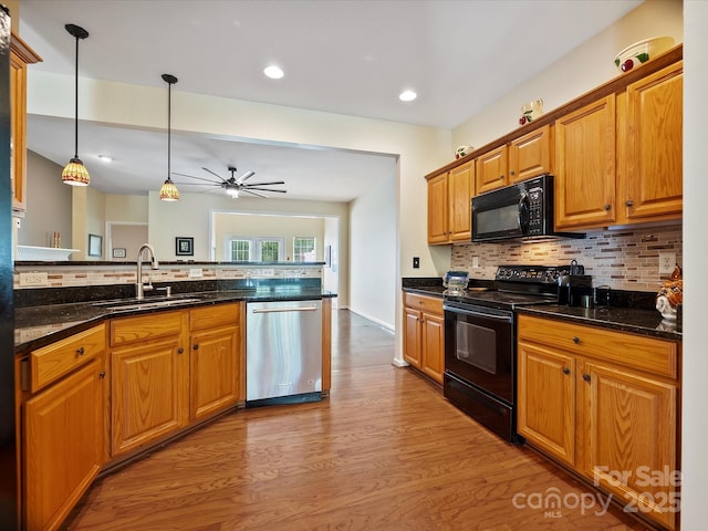 kitchen with ceiling fan, backsplash, decorative light fixtures, black appliances, and light wood-type flooring