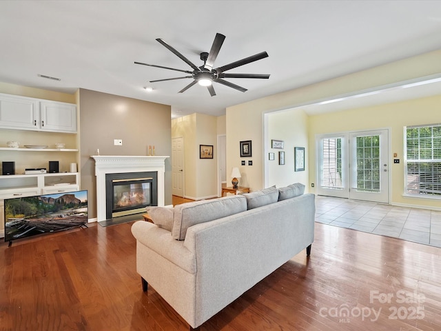 living room with hardwood / wood-style floors and ceiling fan