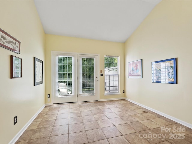 doorway to outside with light tile patterned floors