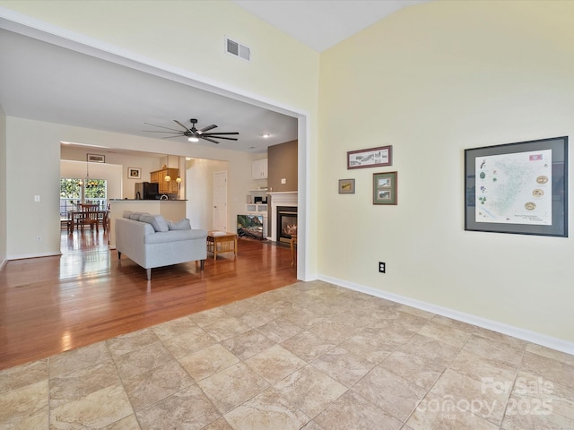 unfurnished living room with ceiling fan