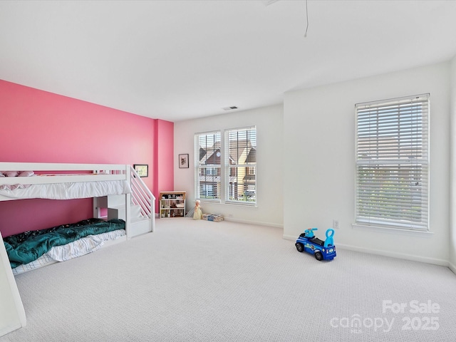 bedroom with carpet and multiple windows