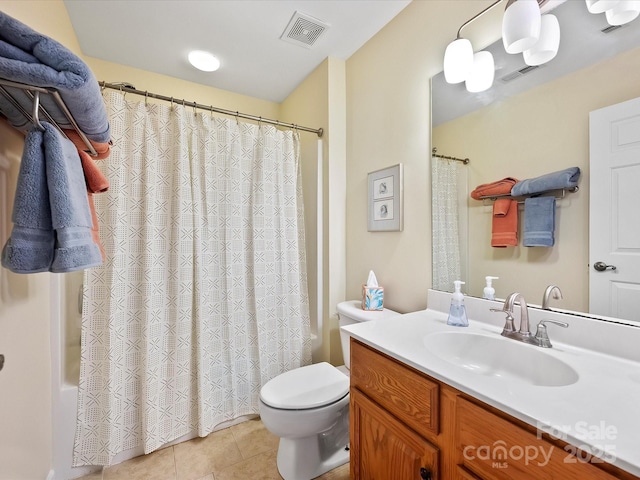 bathroom featuring toilet, vanity, and tile patterned floors