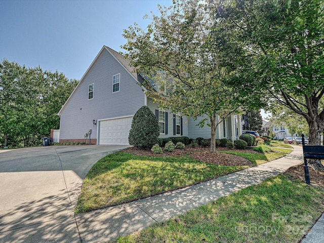 view of front of house with a garage and a front lawn