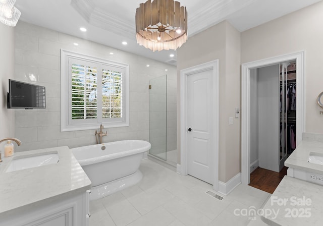 bathroom with crown molding, tile patterned floors, vanity, and shower with separate bathtub