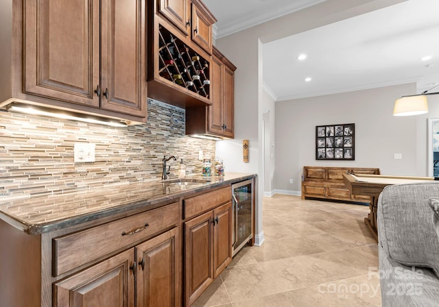 kitchen with ornamental molding, wine cooler, and dark stone counters