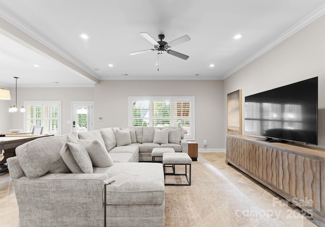 living room with ceiling fan with notable chandelier, ornamental molding, and light tile patterned flooring