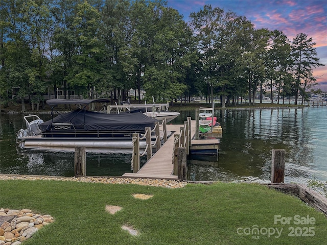 dock area featuring a water view and a lawn