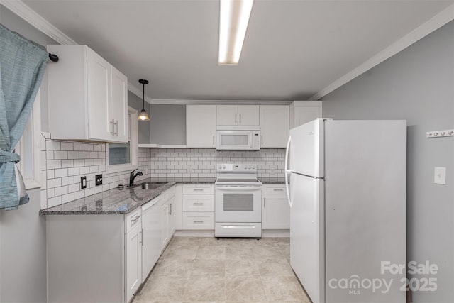 kitchen with sink, white cabinets, pendant lighting, and white appliances