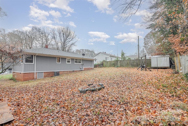 rear view of property with a shed