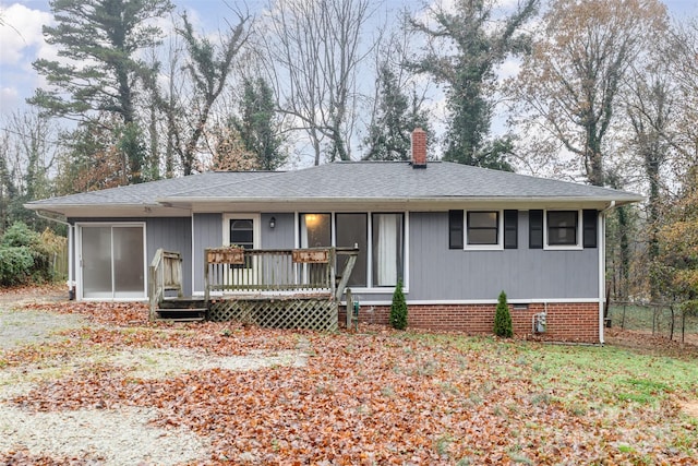 single story home with a wooden deck