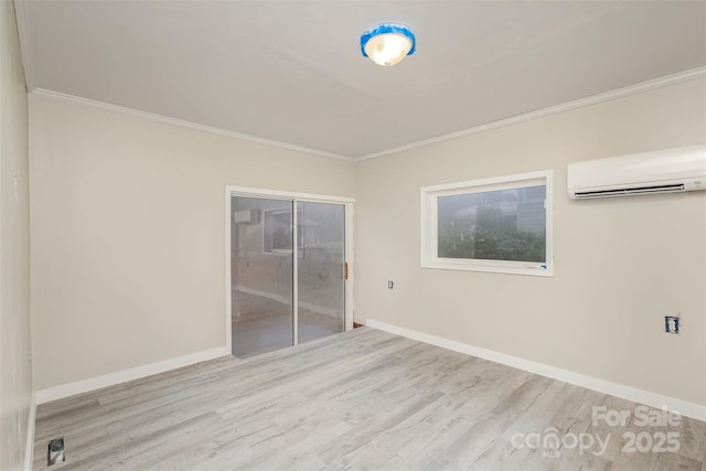 spare room with a wall mounted AC, crown molding, and light wood-type flooring