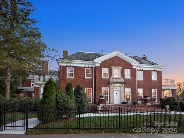 view of front of property featuring a yard and a balcony