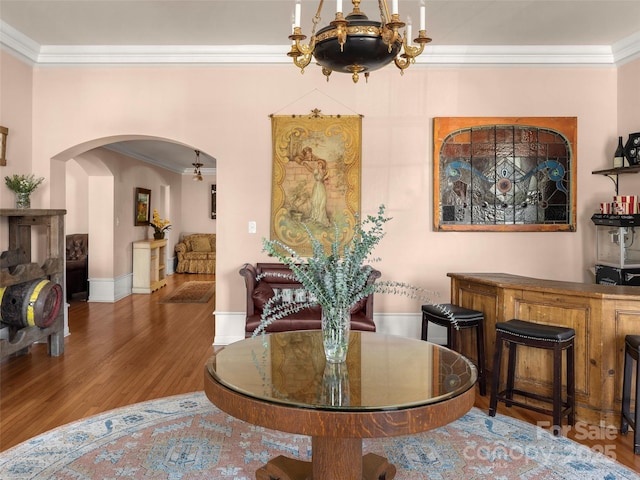 dining room with wood-type flooring and ornamental molding