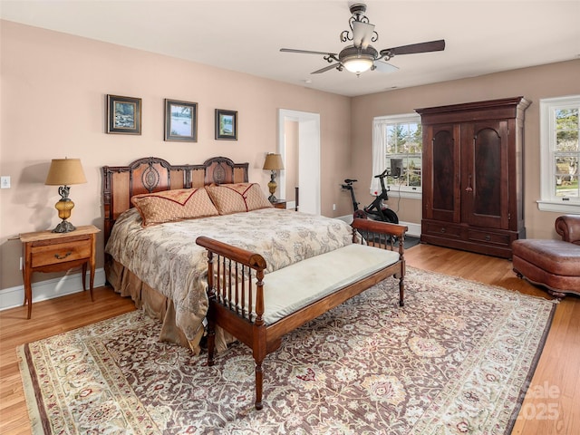 bedroom featuring ceiling fan and light hardwood / wood-style flooring