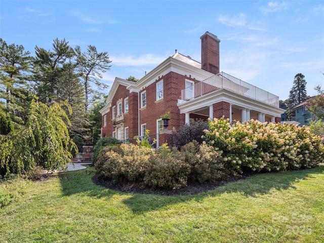 view of property exterior with a yard and a balcony