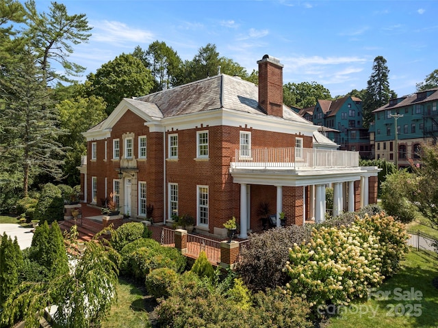 back of property featuring a balcony