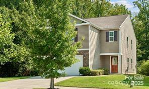 view of front of home with a front yard and a garage