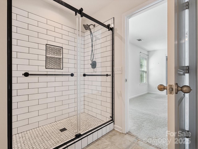 bathroom featuring a shower with door