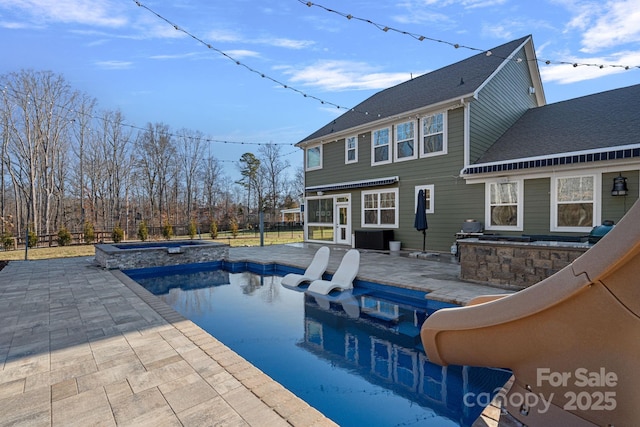 view of pool with an in ground hot tub and a patio