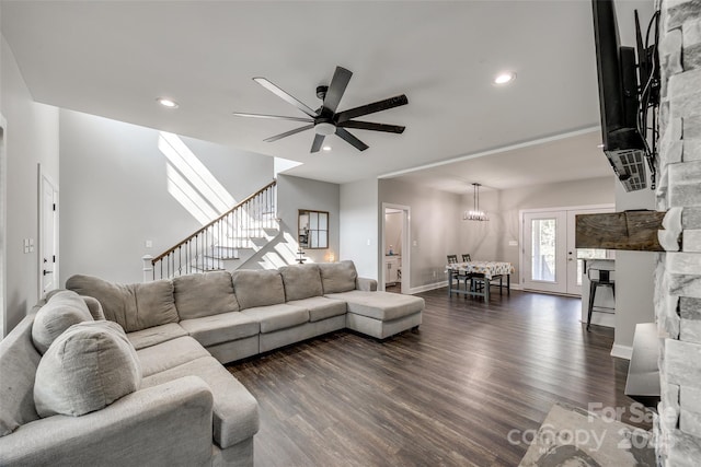 living room with ceiling fan and dark hardwood / wood-style flooring