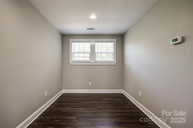 spare room with dark hardwood / wood-style flooring