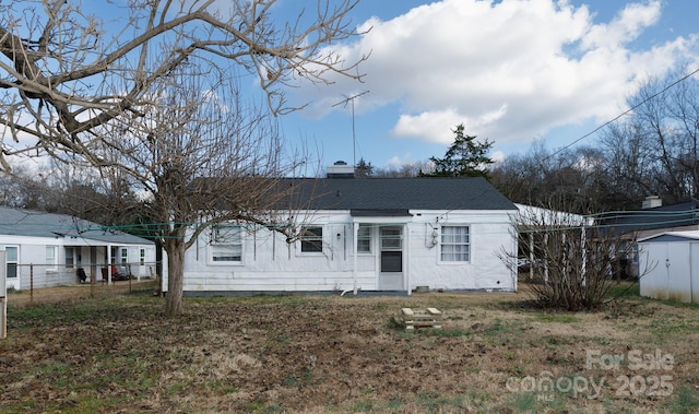 back of property with a shed