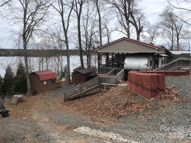 view of front of home featuring a storage shed