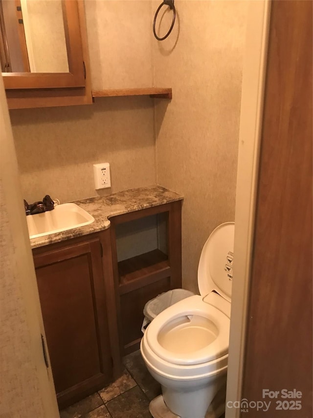 bathroom featuring vanity and toilet