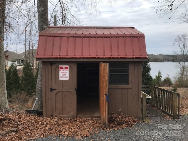 view of outbuilding with a water view