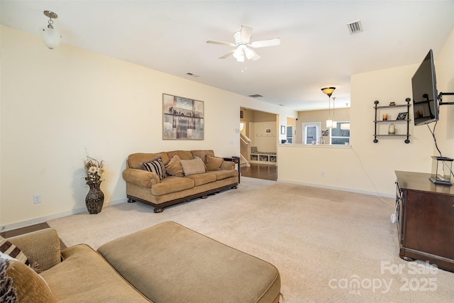 carpeted living room with ceiling fan