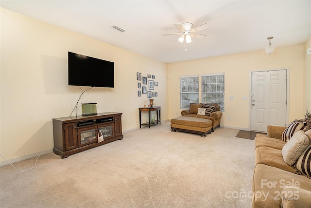 carpeted living room with ceiling fan