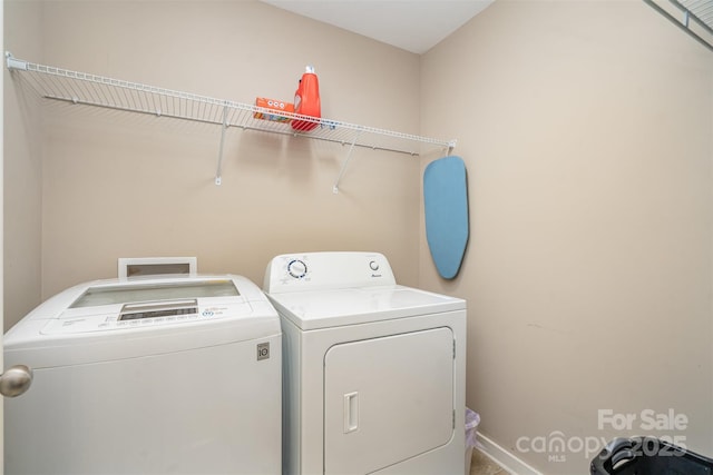 clothes washing area with washing machine and clothes dryer