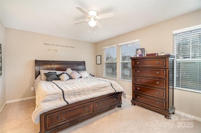 bedroom featuring light carpet, multiple windows, and ceiling fan