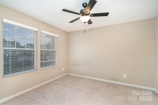 carpeted spare room with ceiling fan