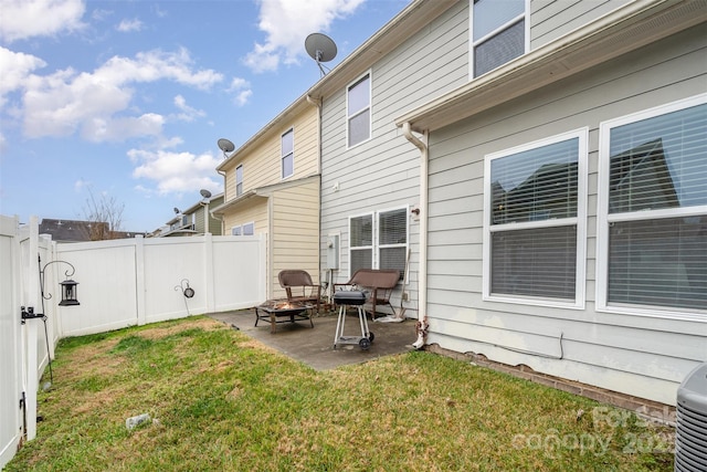 back of property featuring a patio area and a yard