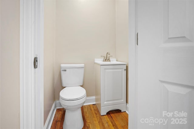 bathroom with vanity, hardwood / wood-style flooring, and toilet