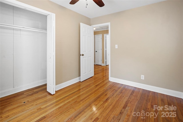 unfurnished bedroom with a closet, light hardwood / wood-style flooring, and ceiling fan