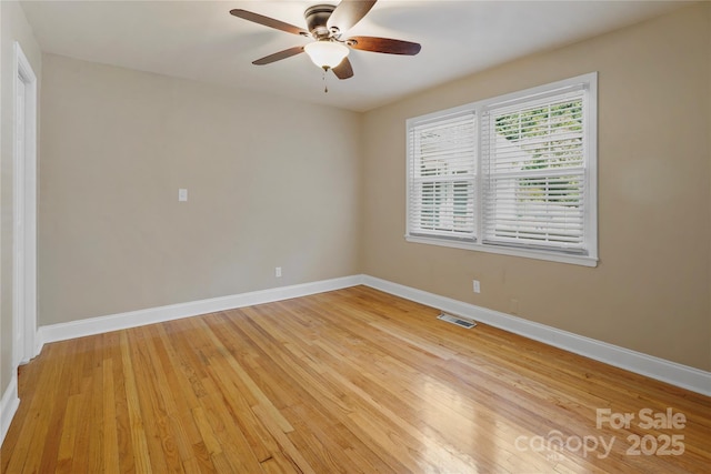 empty room featuring ceiling fan and light hardwood / wood-style flooring