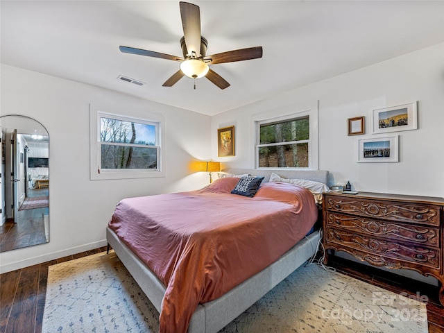 bedroom with ceiling fan and dark hardwood / wood-style floors