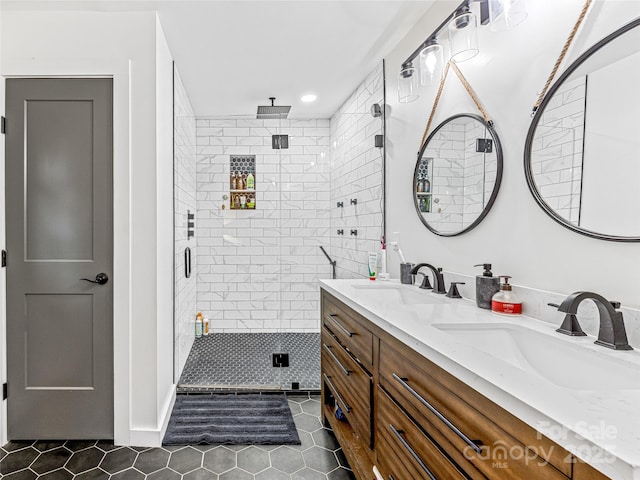 bathroom featuring tile patterned flooring, vanity, and a shower with shower door