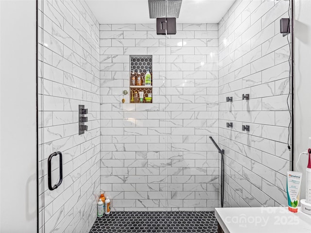 bathroom with a shower with door