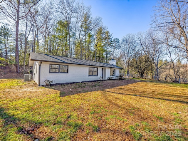 view of home's exterior with a yard and cooling unit