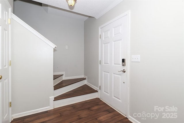 foyer featuring dark hardwood / wood-style floors and a textured ceiling