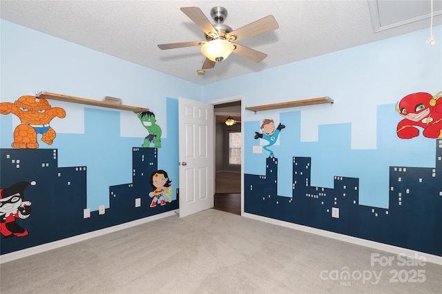 rec room with ceiling fan, light colored carpet, and a textured ceiling