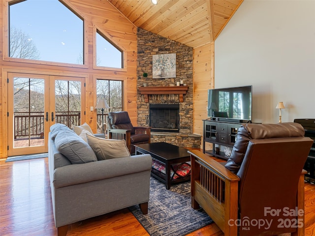 living room with french doors, wooden ceiling, high vaulted ceiling, wood-type flooring, and a fireplace