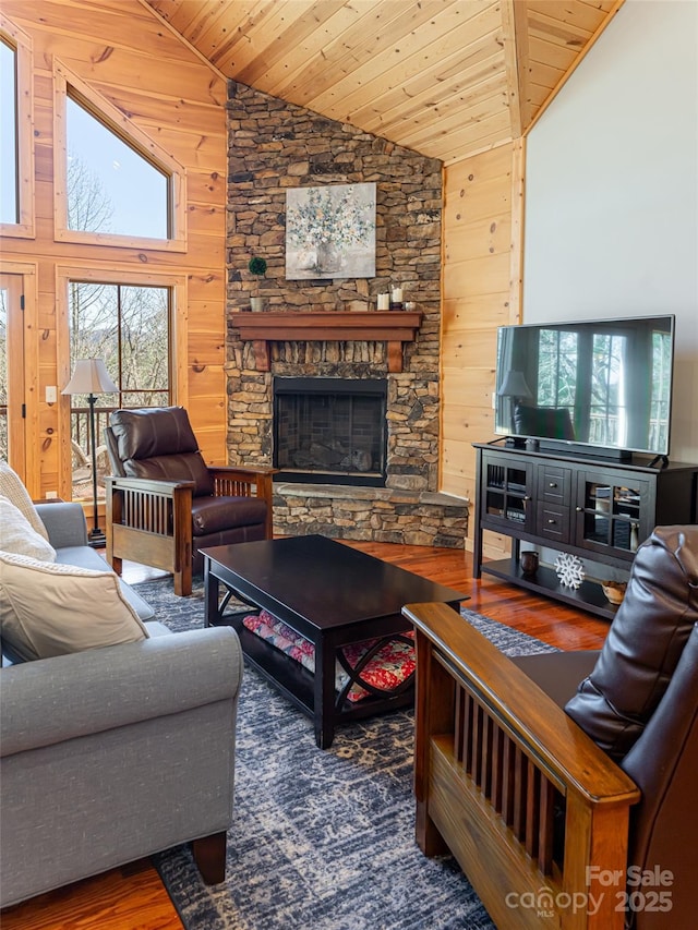 living room featuring wooden ceiling, high vaulted ceiling, wood-type flooring, wooden walls, and a fireplace