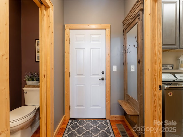 doorway featuring dark hardwood / wood-style flooring and washer / clothes dryer