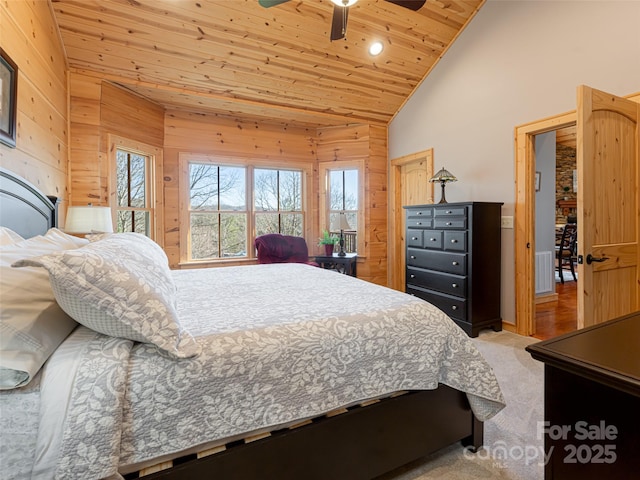 bedroom with wooden ceiling, high vaulted ceiling, wooden walls, ceiling fan, and light colored carpet