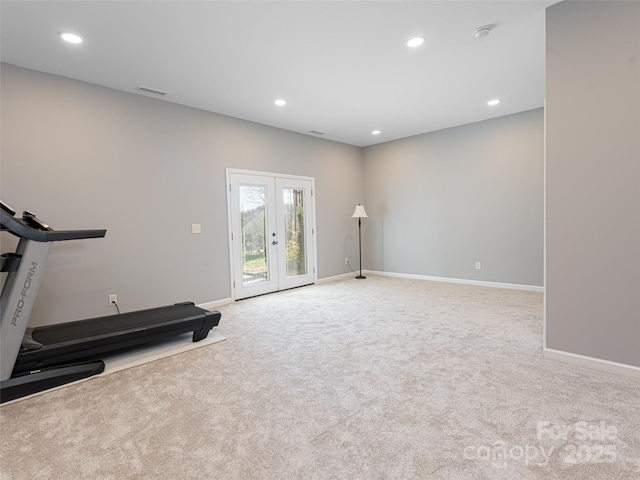 workout room with light carpet and french doors